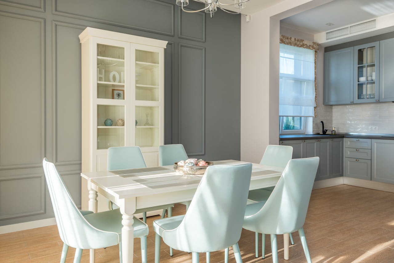 Elegant dining area featuring light blue chairs and a chic cabinet for a tranquil home interior.